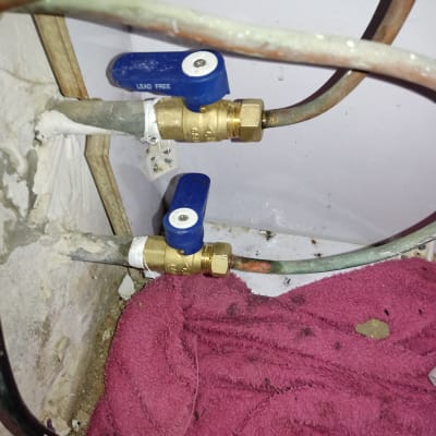 שני ברזי פליז עם ידיות כחולות בצנרת