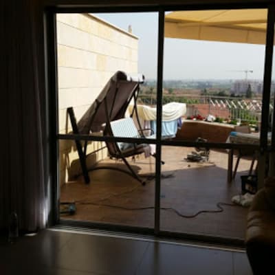 Sliding aluminum door leading to a balcony.