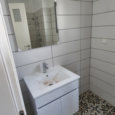 כיור עם ברז ומראה בחדר אמבטיה