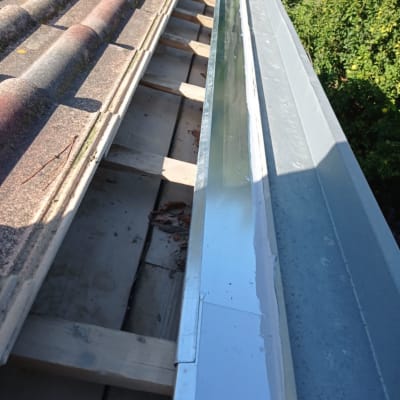 גג רעפים עם תעלת ניקוז מתכתית בצד