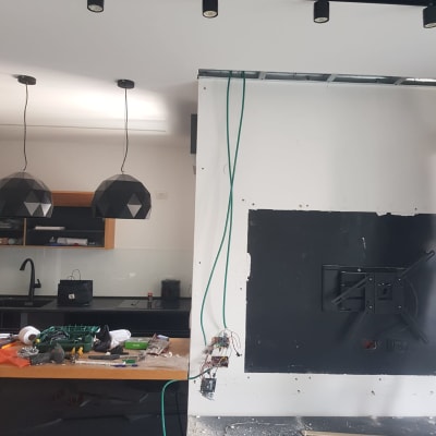 קיר לבן עם חוטים ירוקים, כלי עבודה על שולחן