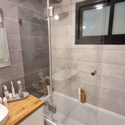 מקלחת עם ראש גשם ודלת זכוכית שקופה