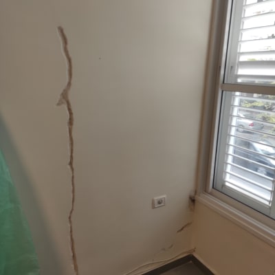קיר עם סדק גדול ליד חלון