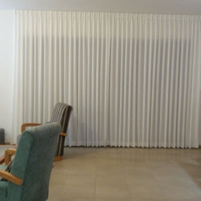 וילון לבן גדול תלוי בסלון מואר