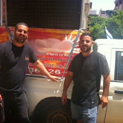 שני אנשים ליד רכב עם פרסומת לדוד שמש