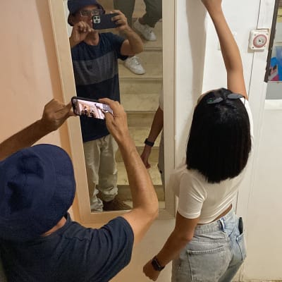 אישה משתמשת בגלאי קיר על קיר לבן