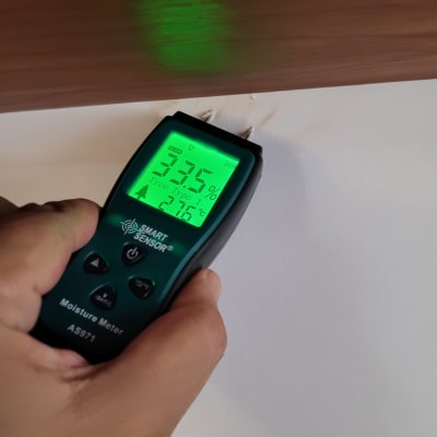 מד לחות נוגע בקיר לבדיקת רטיבות