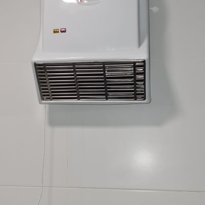 מייבש ידיים חשמלי מותקן על קיר לבן