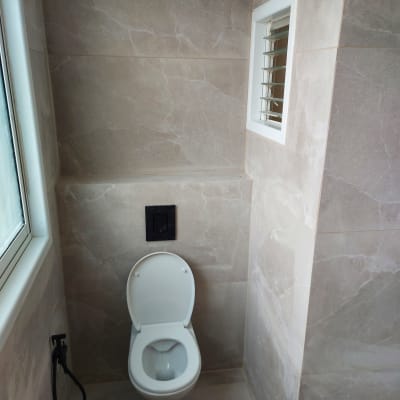 שירותים עם אריחים חדשים ומיכל הדחה נסתר