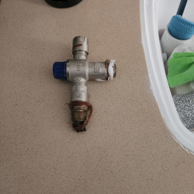 שסתום מתכת עם חיבורים על משטח עבודה