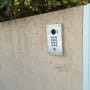 Intercom with camera and keypad on wall