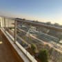 מרפסת עם מעקה זכוכית ונוף לעיר