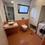 Bathroom with sink, toilet, and washing machine