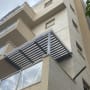סוכך מתכת וזכוכית על מרפסת בניין