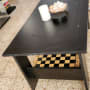 שולחן שחור עם לוח שחמט מתחת