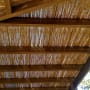 wooden pergola with bamboo roof and wooden beams