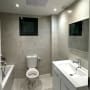 Bathroom with ceiling air vent and recessed lights