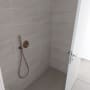 shower area with tiled walls and floor