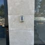 Intercom with keypad on a stone wall