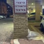 שלט חניה על עמוד לבנים בחניון