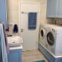 חדר כביסה עם מכונת כביסה ומייבש