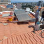 Roof sealing with buckets and tools visible