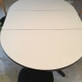 Oval table with wooden chairs around it