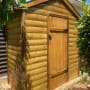 מחסן עץ בגינה עם דלת סגורה