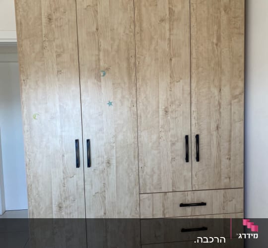 ארון עץ עם ידיות שחורות ומדבקות קטנות