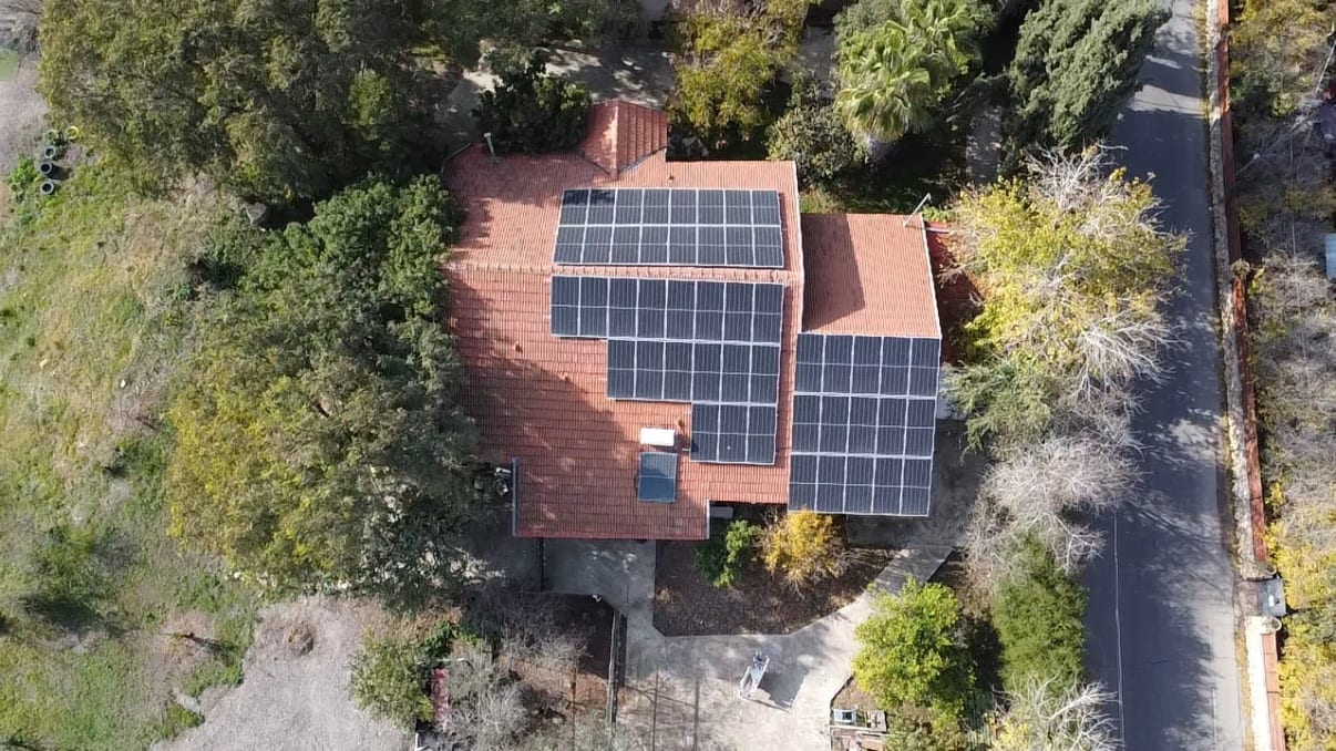 פאנלים סולאריים מותקנים על גג רעפים אדום