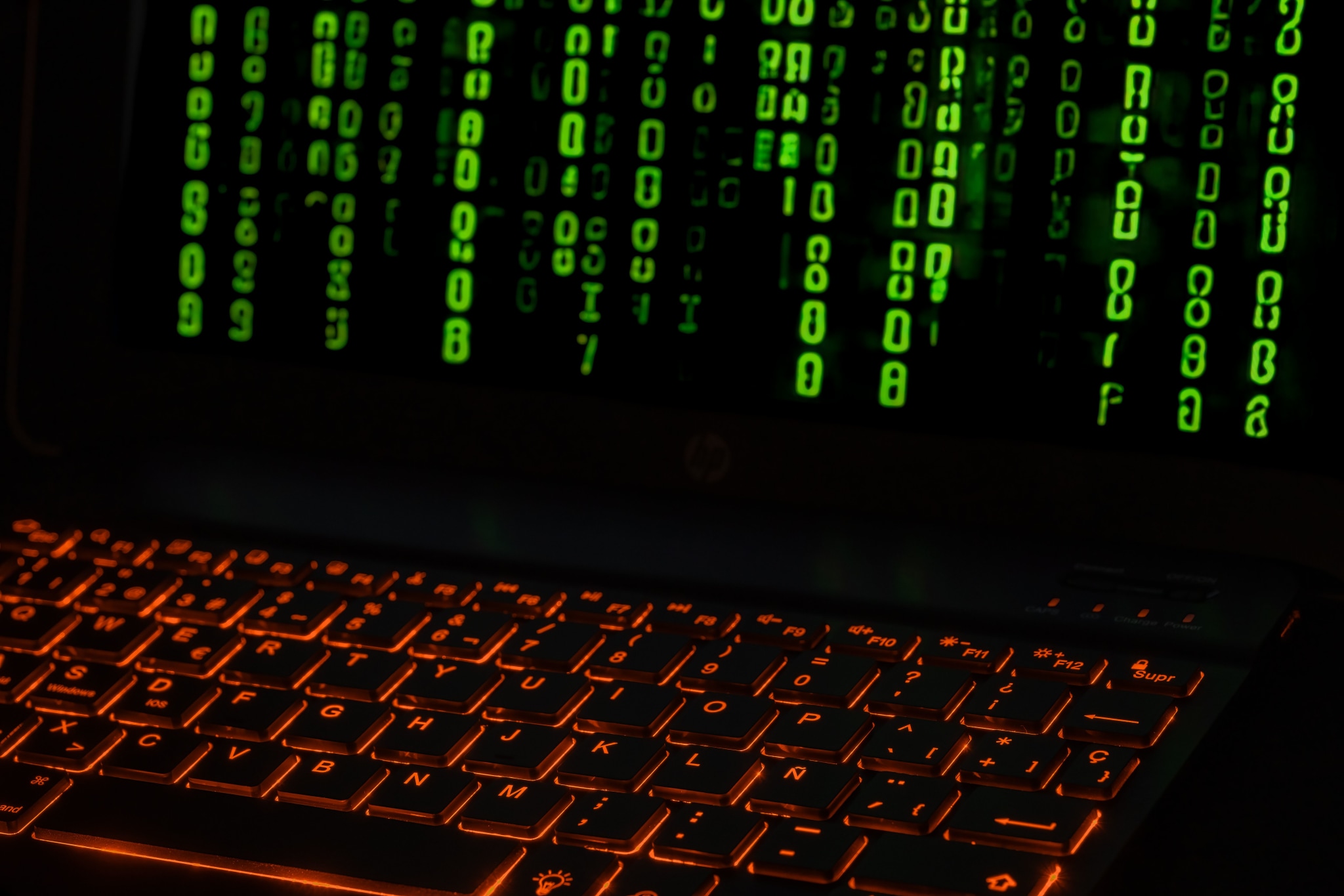 An illuminated keyboard displaying green digital code.