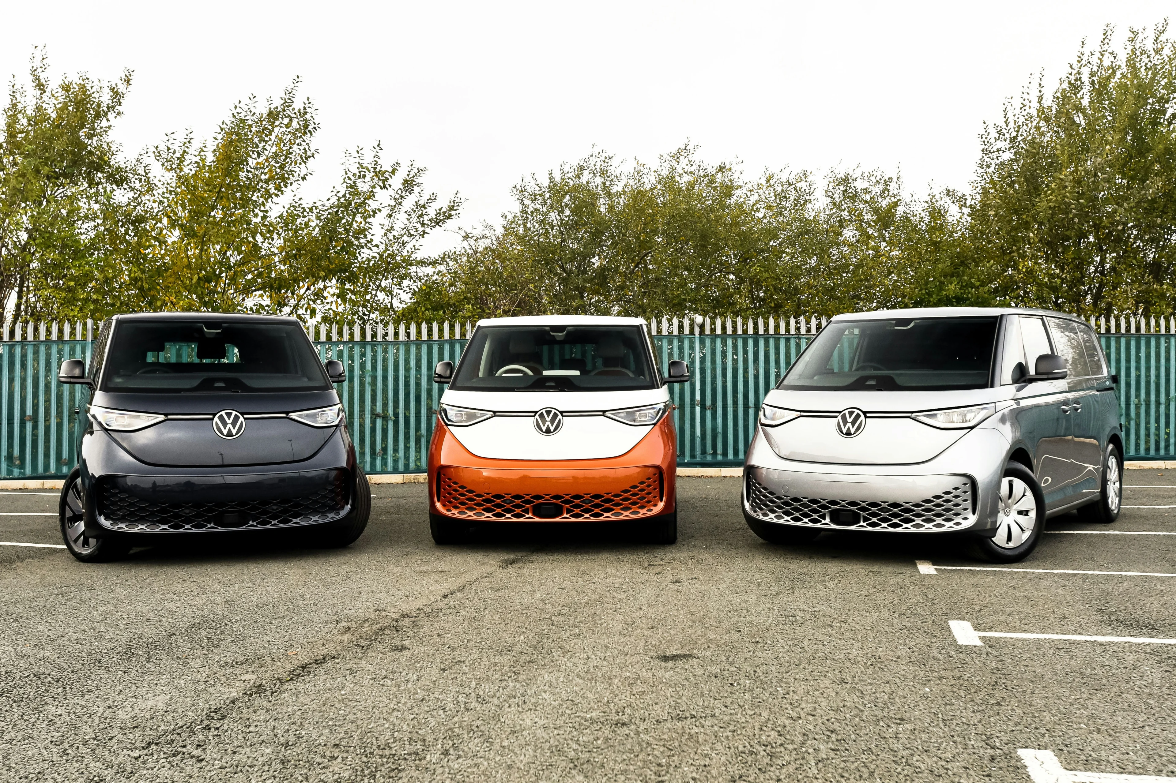 Three Volkswagen electric vehicles parked in a row