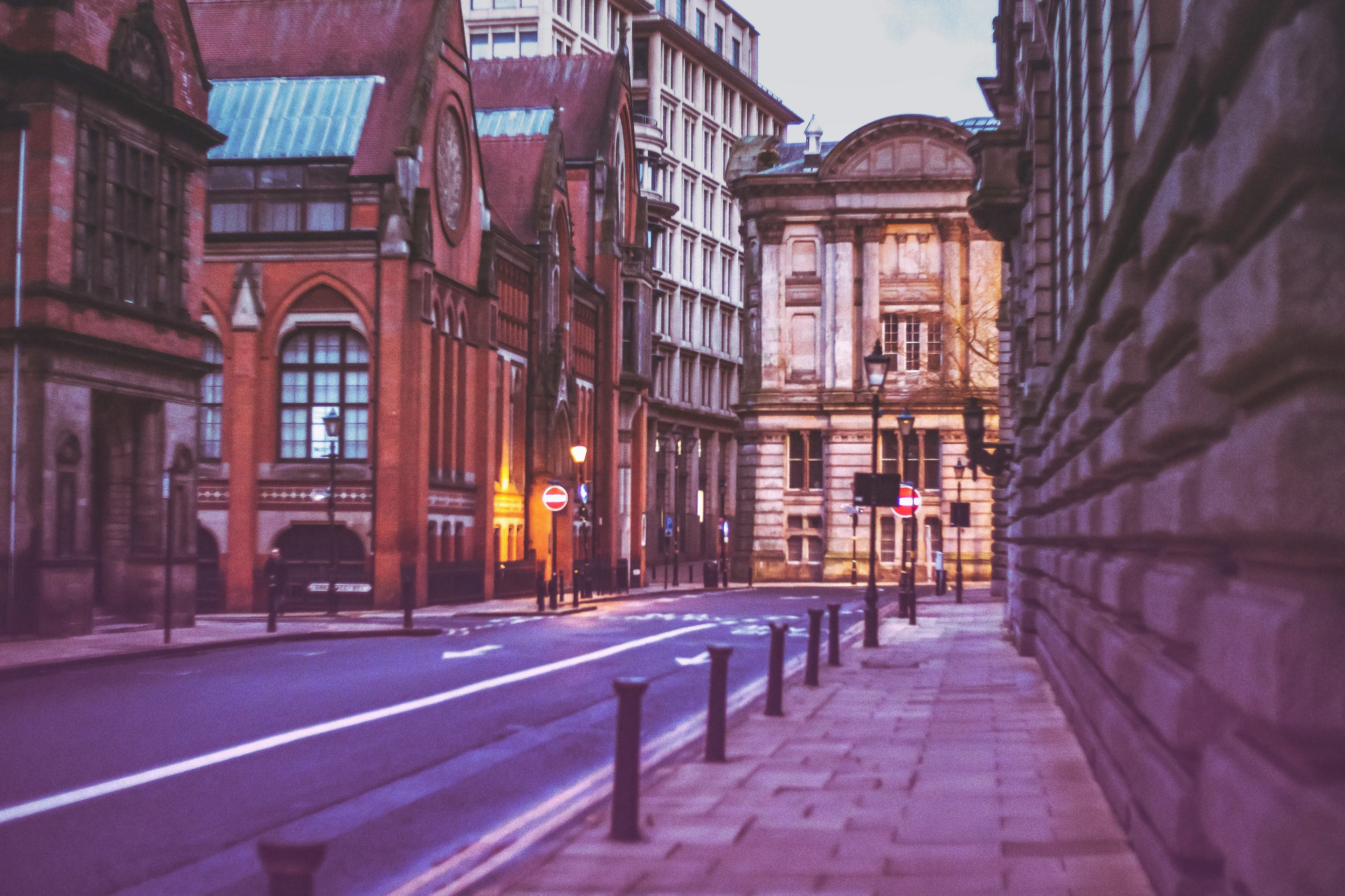 City road lined with historic buildings in the UK