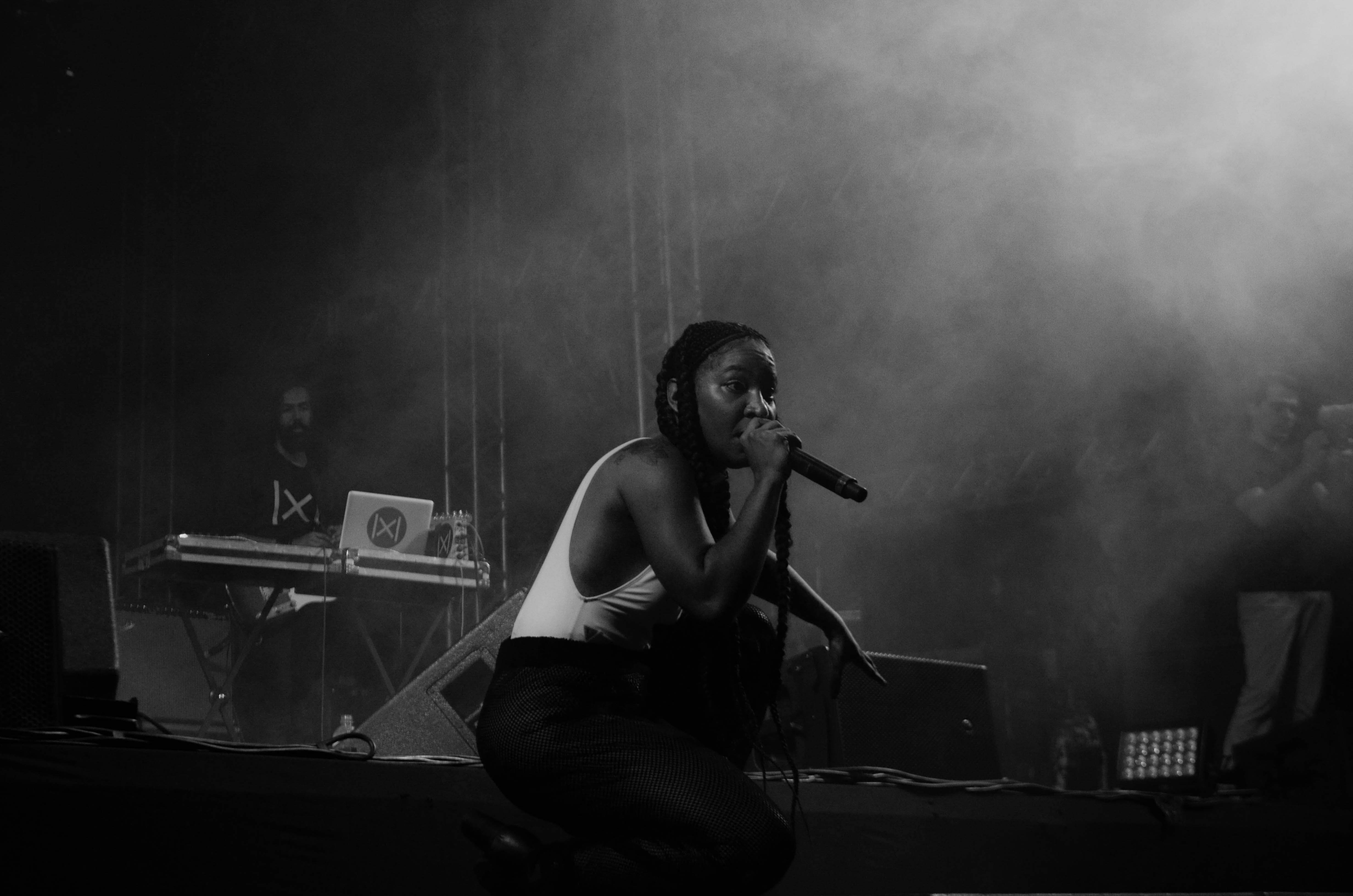 A performer singing into a handheld microphone