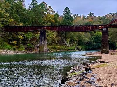 Tall train trestle spanning the Caddo River.