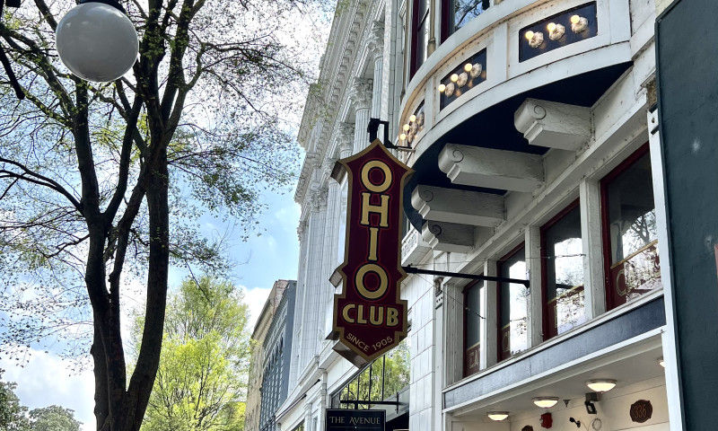 Victorian era commercial building entrance with large Ohio Club sign.