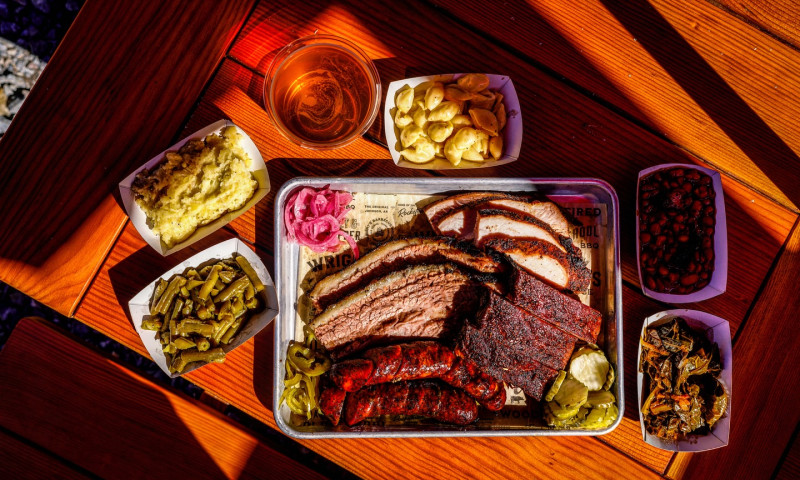 Tray of BBQ surrounded by sides