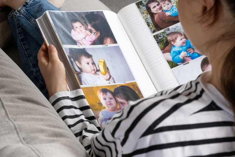 Woman with photo album and family