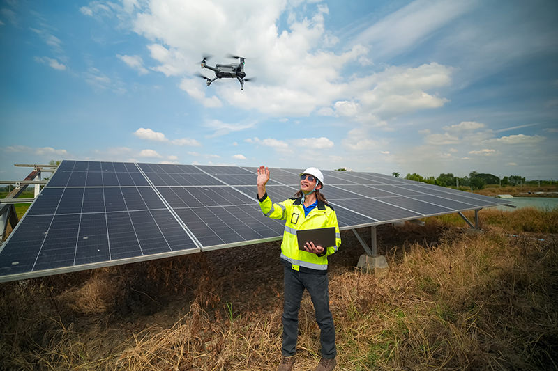 Drone inspecting solar panels on a solar farm