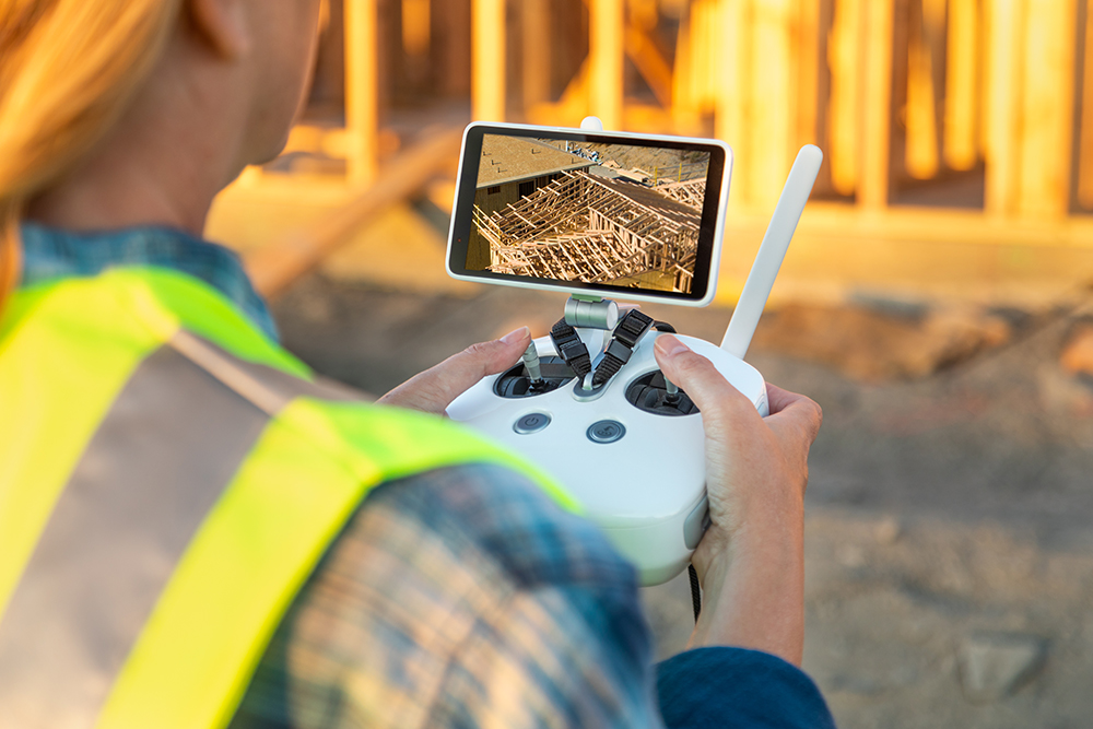 Drone scanning a construction site with 3D overlay