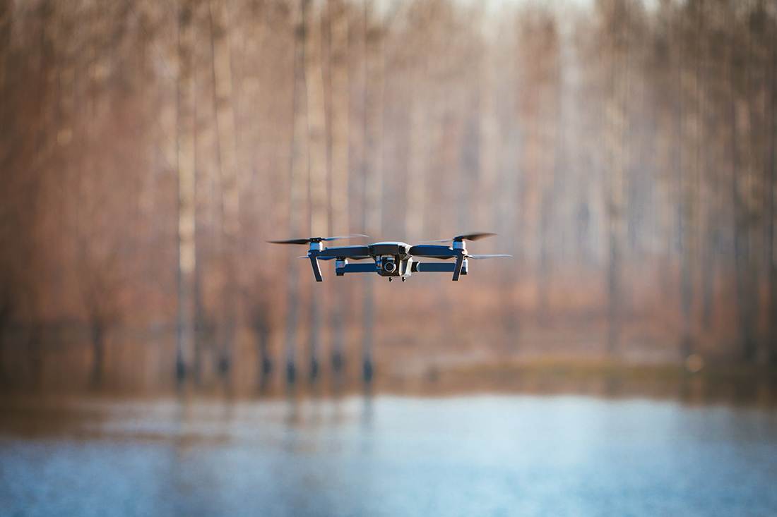 Drone flying over flooded area capturing data