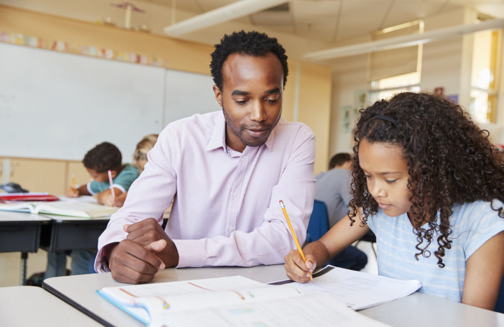elementary-school-teacher-working-with-schoolgirl-GRUXL36_Crop elementary-school-teacher-working-with-schoolgirl-GRUXL36_Crop