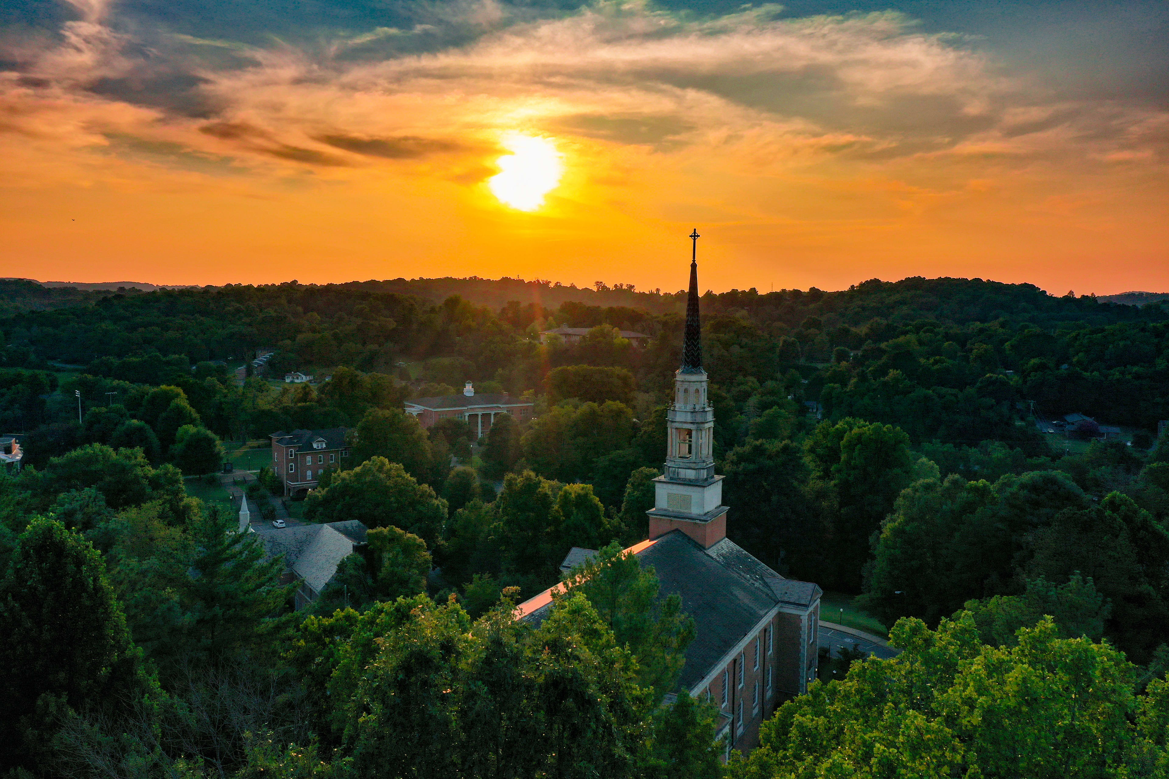 Seeger Chapel steeple against an orange sunset