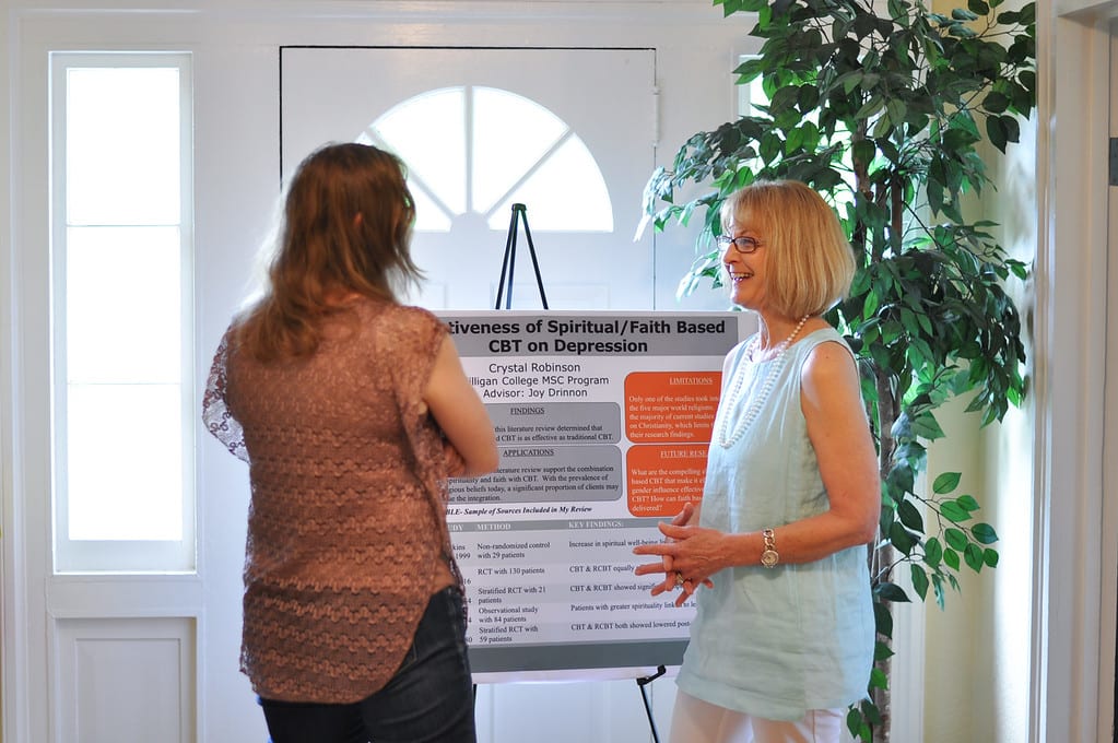Counseling student with professor at research conference