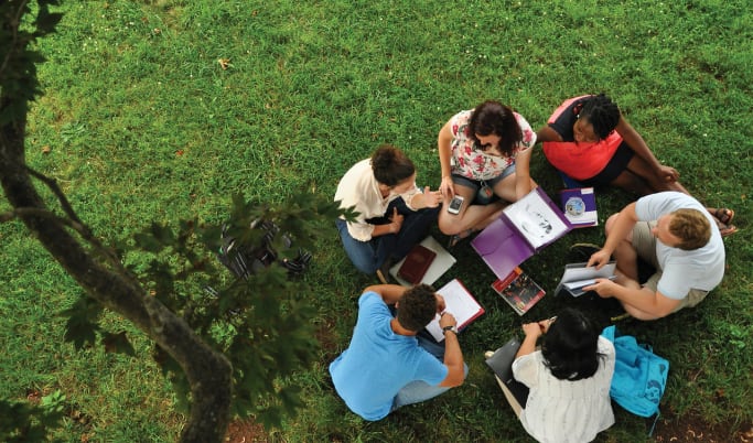Milligan students studying on the library lawn