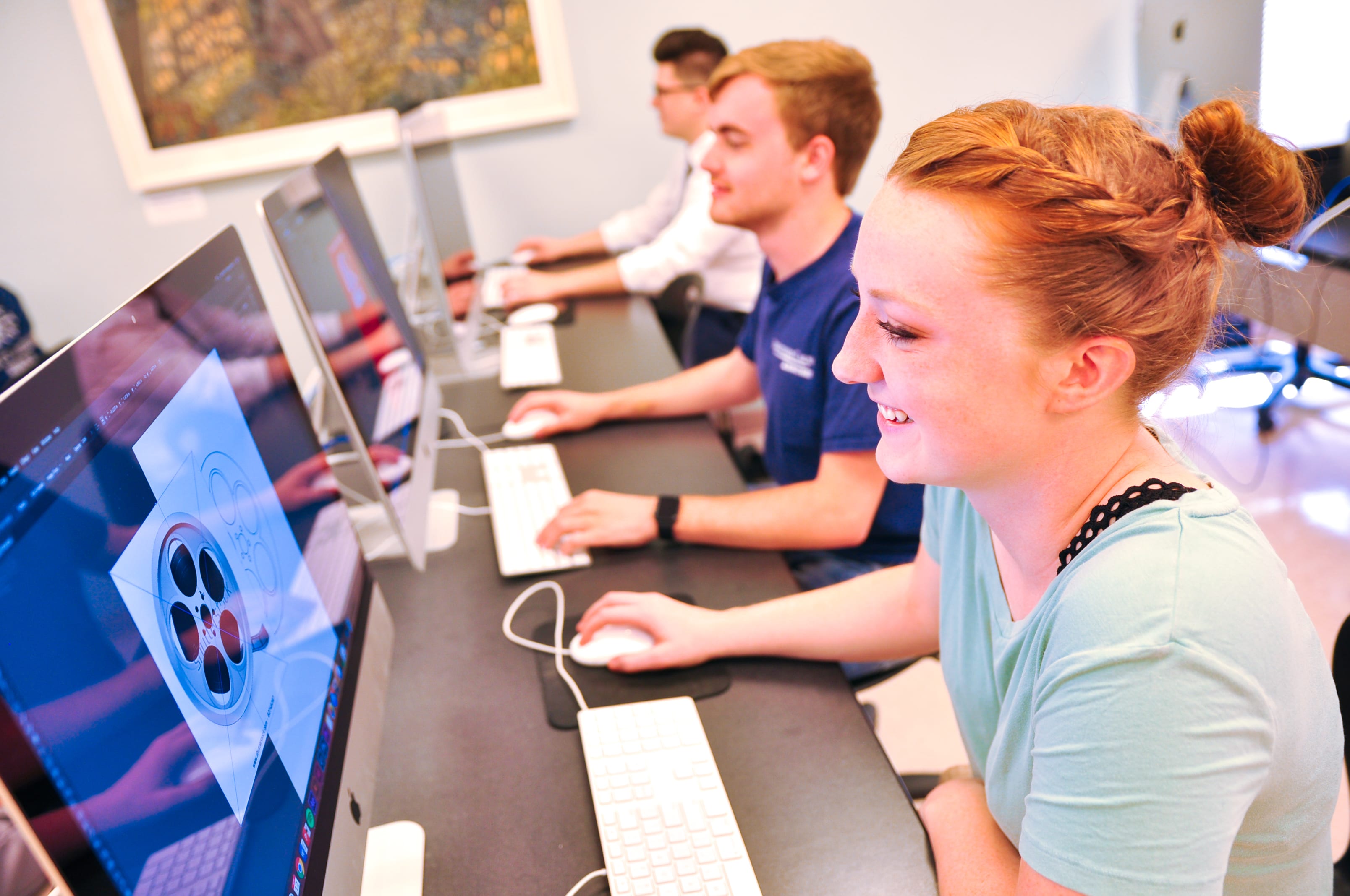 graphic design students working in the MAC lab