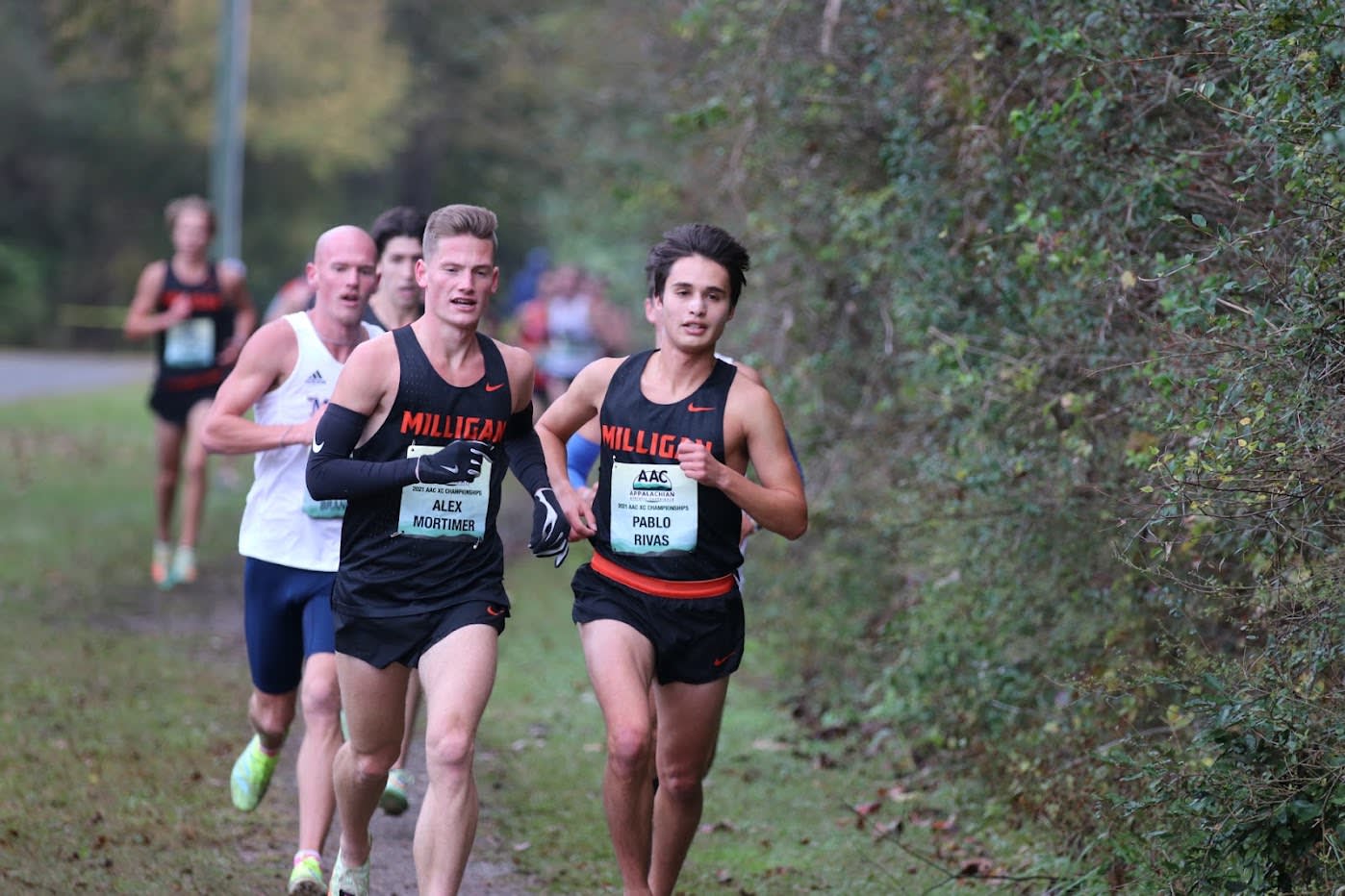 Two Milligan XC Runners competing at a conference championship
