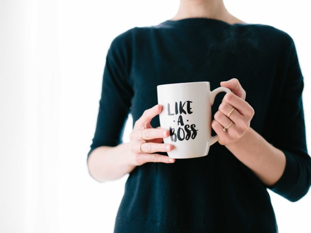 Photo of a woman holding a mug in her hands