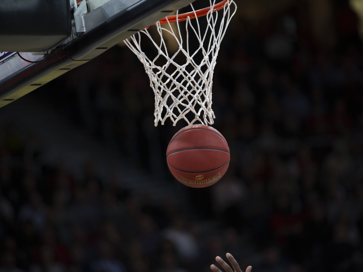 A basketball ball that just went through the basket