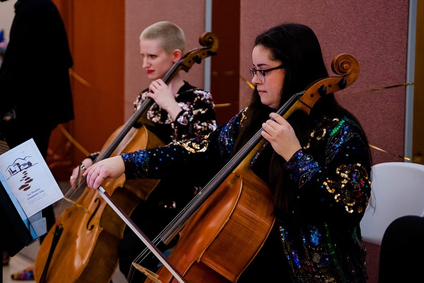 Sonia Mantell and Esther Seitz seated and playing cello at Our Lady of Guadalupe Church in St. Paul.